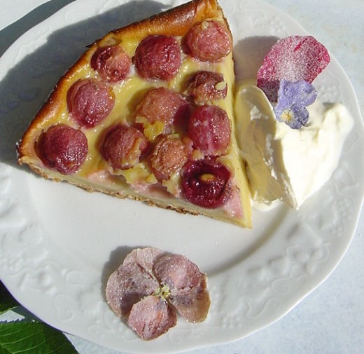 Clafouti decorated with sugared flowers.