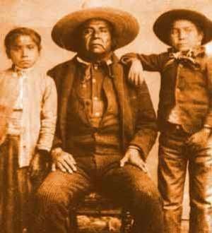 A public domain photo believed to be CHief Cochise and two native children.