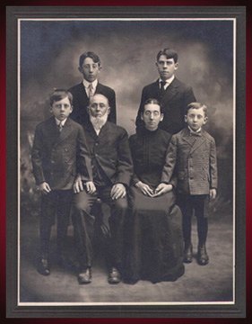 With his natal family, top right.