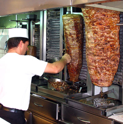 This man is working on meat for gyros.  This is a familiar sight around Greece, in souvlaki shops everywhere. 