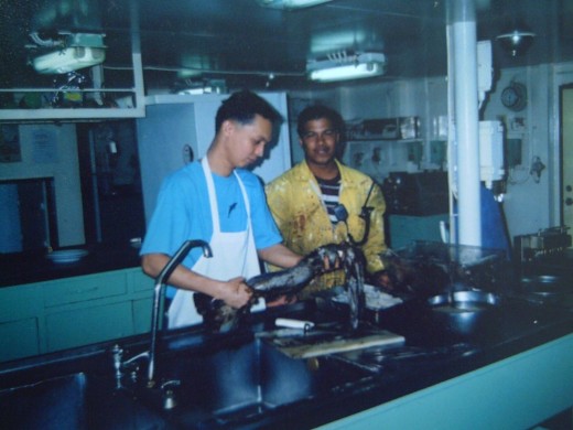 TRAVEL MAN with a Filipino AB while sorting out HUGE SQUIDS, their fresh catch from TALARA, PERU (2003)