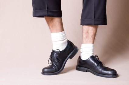 A men wearing white socks. The picture also shows what happens if your socks (no matter what color they are) are too short and you are sitting down. It's better to get longer socks that can go all the way up to your knees!
