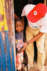 A Kenya Red Cross volunteer from the Kajiado branch, walks door to door registering children who need measles vaccinations and encouraging mothers to bring their children to the closest vaccination post.  