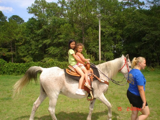 Lexi and Madison riding an old Arabian mare.