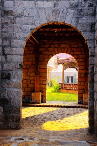 arch frames a Spanish era structure