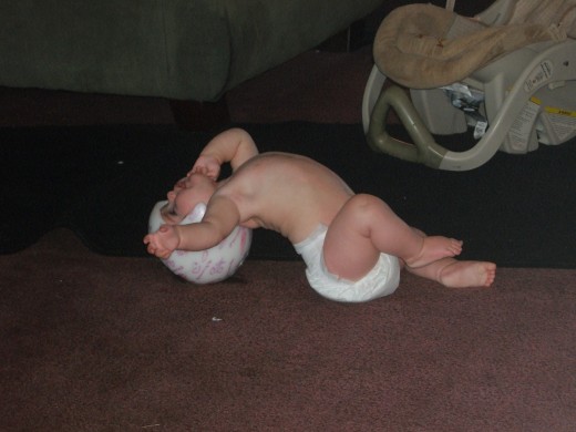 Crawling backwards and on her head!