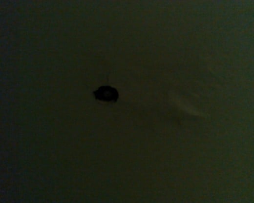 Our bedroom ceiling after Rich put it back together. The  hole is for our sprinkler valve.
