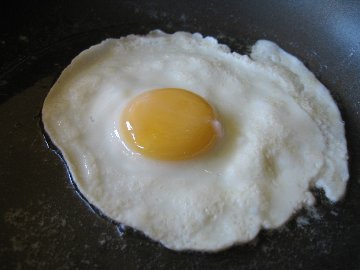 Frying eggs in small pans and flipping them isn't that hard but it does take non stick pans and a little practice to get where you can do it right. 