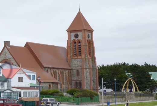 Christ Church Cathedral Anglican Church in downtown Stanley with its whalebone arch to the right.