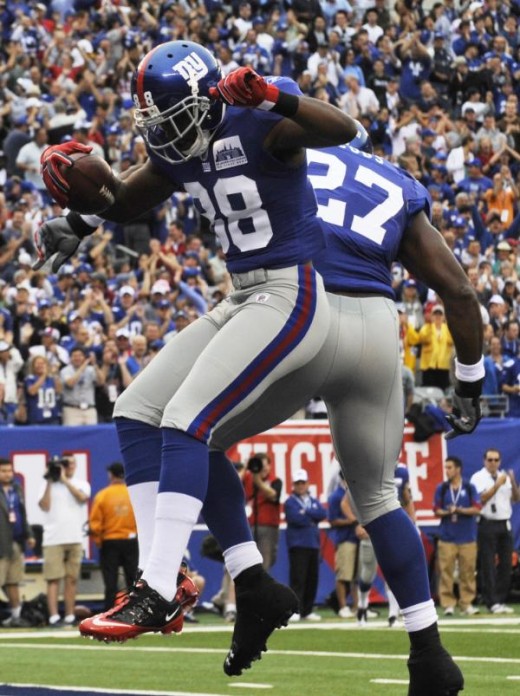 New York Giants wide receiver Hakeem Nicks (88) celebrates with Brandon Jacobs (27) after catching a touchdown pass during the first quarter of an NFL football game against the Carolina Panthers at New Meadowlands Stadium in East Rutherford, N.J., Su