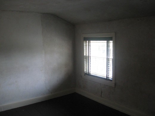 the bare rooms are cast with a gloomy light