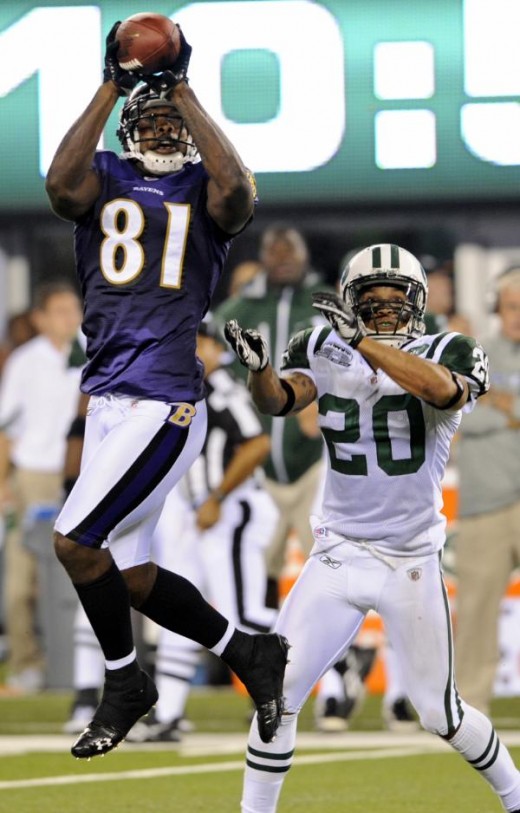 Baltimore Ravens' Anquan Boldin (81) catches a pass as New York Jets' Kyle Wilson (20) looks on during the third quarter of an NFL football game at New Meadowlands Stadium in East Rutherford, N.J., Monday, Sept. 13, 2010. The Ravens won 10-9. (AP Pho