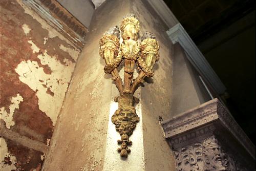 This is a photo of one of the two 100+ year old sconces that are on either side of the fireplace, before restoration.