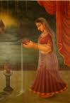 An indian woman prays to Goddess Tulsi