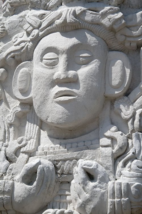 This is a Maya carving, likely of an important person. There are a huge number of carvings on temples and stellae over the entire region of their homeland. Many contain writing.
