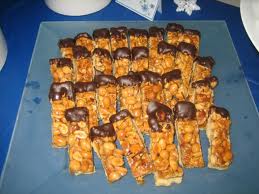 Nutty rolls dipped in chocolate and more nuts are crunchy party treats.