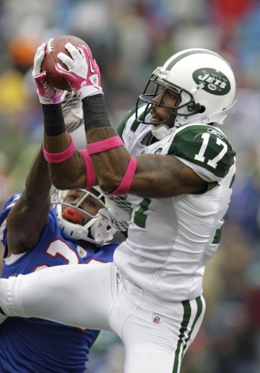 New York Jets' Braylon Edwards (17) makes a 19-yard catch under pressure from Buffalo Bills' Drayton Florence (29) during the second half of the NFL football game in Orchard Park, N.Y., Sunday, Oct. 3, 2010. The Jets won 38-14. (AP Photo/ David Dupre