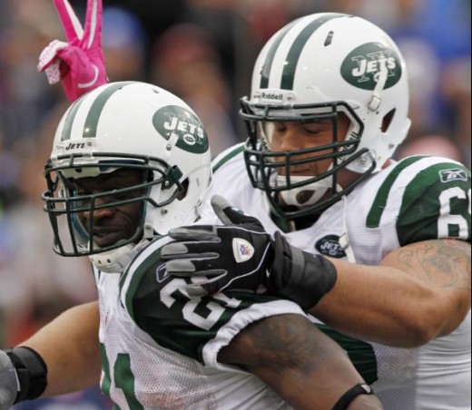 New York Jets running back LaDainian Tomlinson (21) celebrates a touchdown with teammate Matt Slauson during the second half of an NFL football game against the Buffalo Bills in Orchard Park, N.Y., Sunday, Oct. 3, 2010. The Jets won, 38-14. (AP Photo