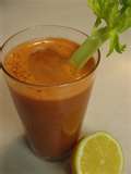 Healthy, delicious carrot juice with a stalk to garnish it, and a hint of freshly squeezed lemon!