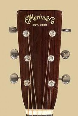 A common headstock of a Martin guitar, which is usually a very uncommon instrument of great value.