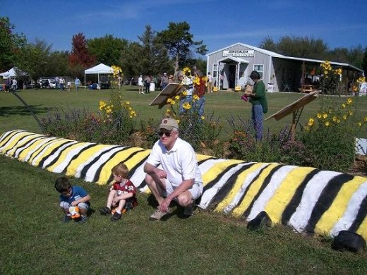 Grandpa and grand-kids enjoying the warm sunshine and Mr. Caterpillar at the Festival.  