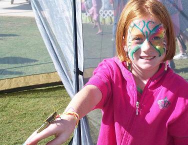 This young lady caught the huge grasshopper at an edge of the butterfly tent and displayed it for the camera.  