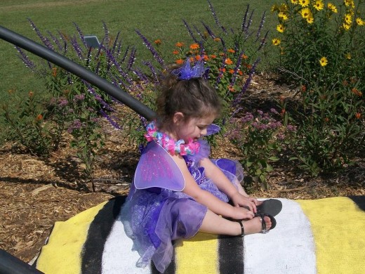 This darling purple butterfly shyly posed on Mr. Caterpillar while Daddy encouraged her.  She was a sweet  little butterfly.