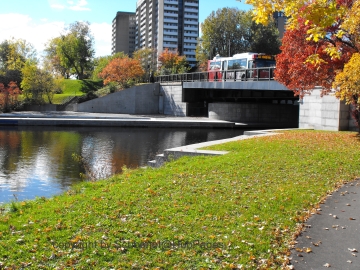 Leading to the Rideau Canal via the boat locks, note the city and the traffic over the bridge