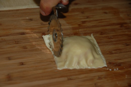 Folded over with filling in place, crimp with your finger and trim with a fancy pastry knife.