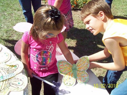 Michael was a cheerful assistant in tying on the butterfly gifts to wrists, where they would flutter about in the Children's Parade.