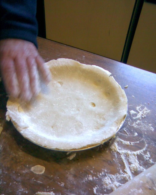roll into a round shape, then place in round pie plate. Trim edges.