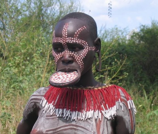 The Mursi women are famous for wearing plates in their lower lip and earlobes