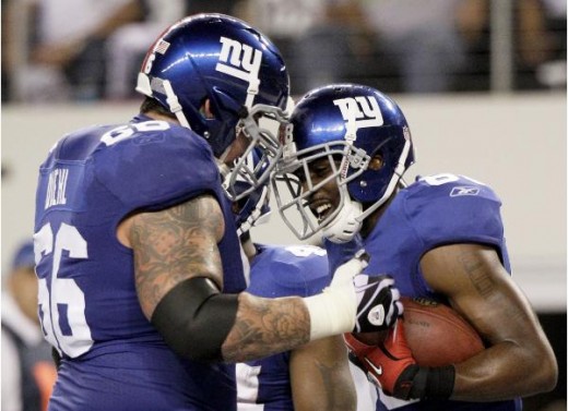 New York Giants wide receiver Hakeem Nicks celebrates his touchdown against the Dallas Cowboys with David Diehl during the first half of an NFL football game Monday, Oct. 25, 2010, in Arlington, Texas. (AP Photo/LM Otero)
