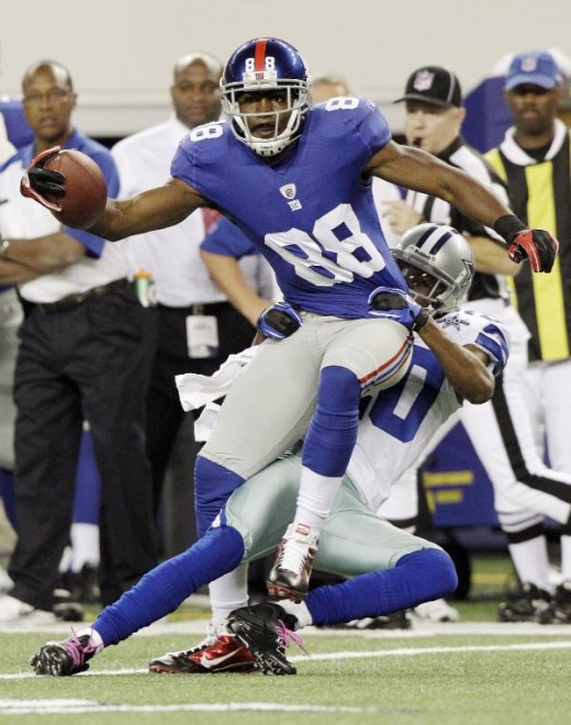 New York Giants wide receiver Hakeem Nicks is tackled by Dallas Cowboys cornerback Alan Ball during the first half of an NFL football game Monday, Oct. 25, 2010, in Arlington, Texas. (AP Photo/LM Otero)