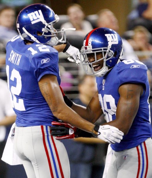 New York Giants wide receiver Steve Smith, left, celebrates his first-half touchdown with Hakeem Nicks against the Dallas Cowboys during an NFL football game Monday, Oct. 25, 2010, in Arlington, Texas. (AP Photo/Mike Fuentes)