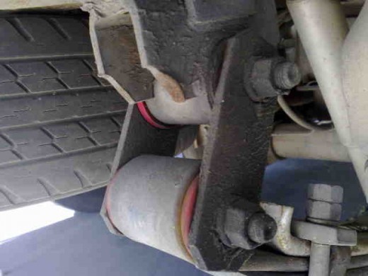 Check spring shackles for any signs of wear. This requires a good eye for the bolt being central in the bush, and often it is easy to pull one side of the shackle of and look at how neat the fit is. Movement here will make the vehicle throttle steer.
