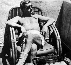 Faulkner enjoying the sun and his ubiquitous pipe.