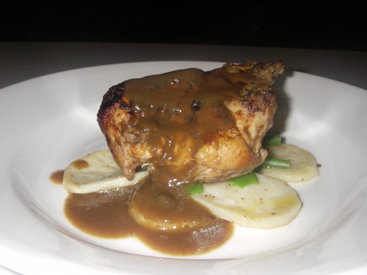 On warmed plates, place potato chips, steamed greens & chicken, pour the gravy mixture on. 
