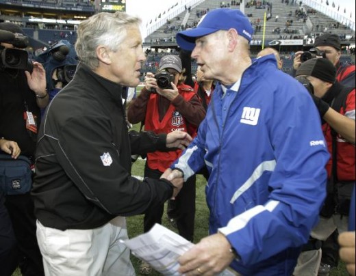 Seattle Seahawks head coach Pete Carroll, left, and New York Giants head coach Tom Coughlin, right, shake hands following an NFL football game, Sunday, Nov. 7, 2010, in Seattle. The Giants beat the Seahawks, 41-7. (AP Photo/Ted S. Warren)