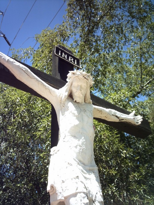 Close up photo of life size sculpture of Christ on the Cross in Tucson's Garden of Gethsemane Felix Lucero Park.