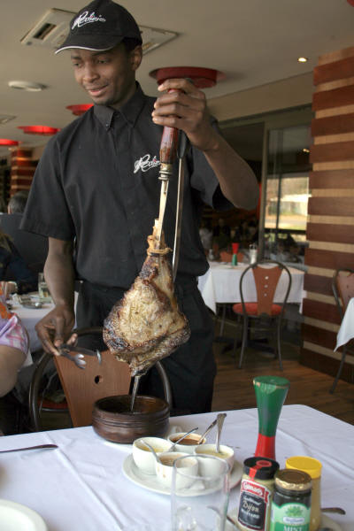 Meat being carved from a skewer - this continues while the green hour glass shows