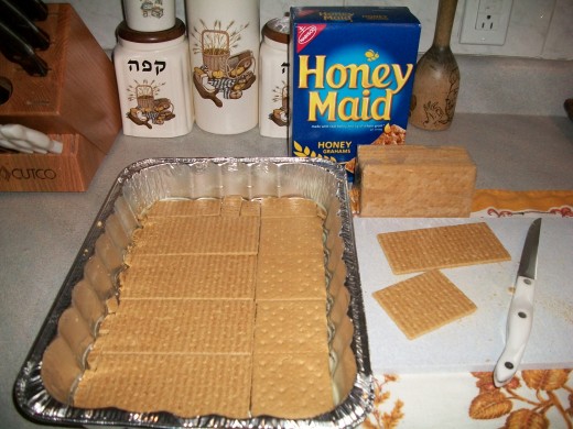 Butter the bottom of a 9x13 pan. Line with the first layer of whole Graham crackers. Cut them to fit.
