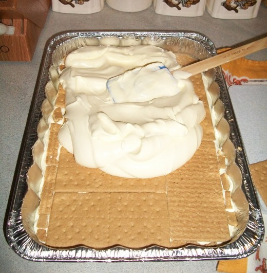 Spread another part of pudding/Cool Whip mix over second layer of crackers.