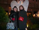 A picture of me and my mom behind a lit angel.