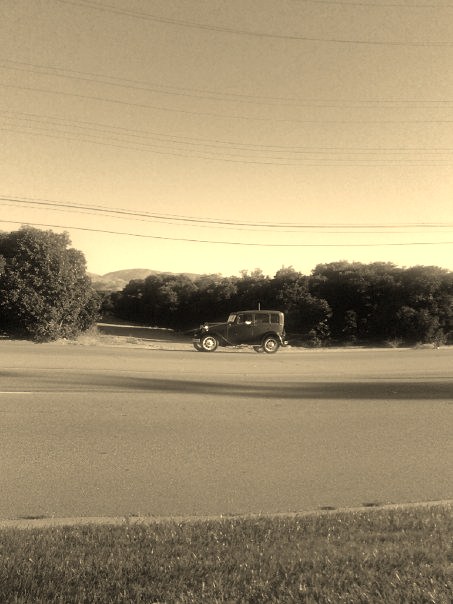 My all time favorite picture that I took of a 1930s style car driving past an orange field in 2008.  The sepia tones makes this picture look very old nostalgic.