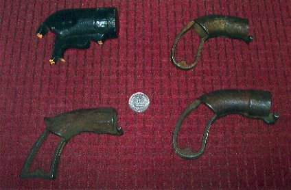 The progression of design for the Leonard pistol can be seen in these four frames.  The one in the upper left is a wooden pattern model.