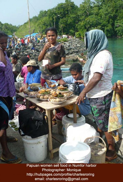 Women sell food at the harbor of Numfor island