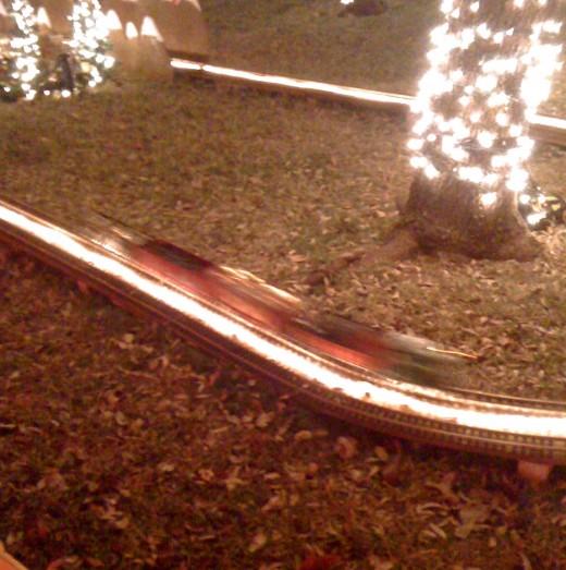 An electric train around the tree.