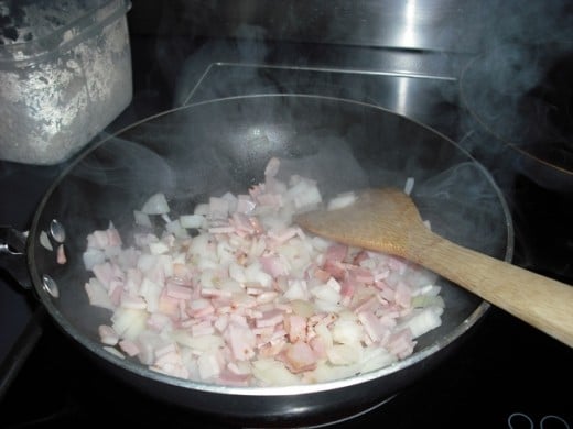 This is the first step with the bacon and onion cooking in a hot wok.