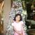 My daughter in front of one old cans Christmas tree in my local mall.